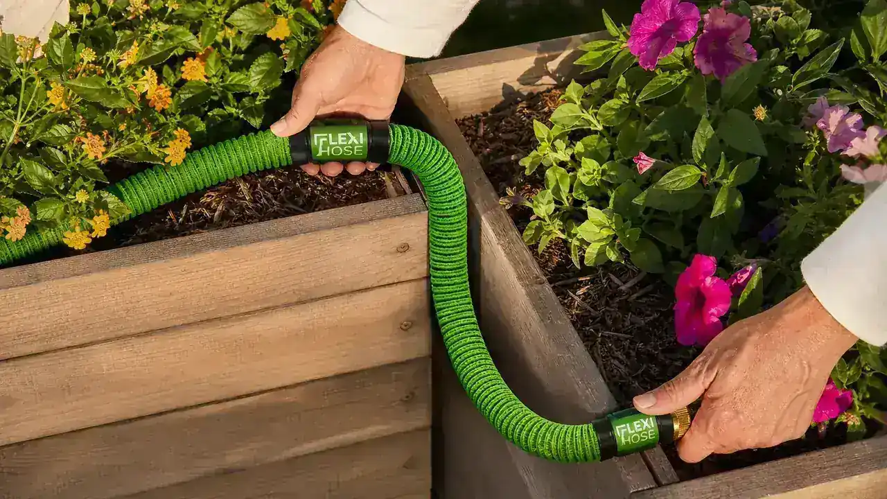 Expandable hose hanging compactly on a wall hook in a small garage storage area